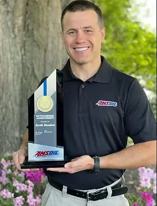 Scott McAdoo of Officer Oil holding his AMSOIL Outstanding Achievement award in Annapolis
